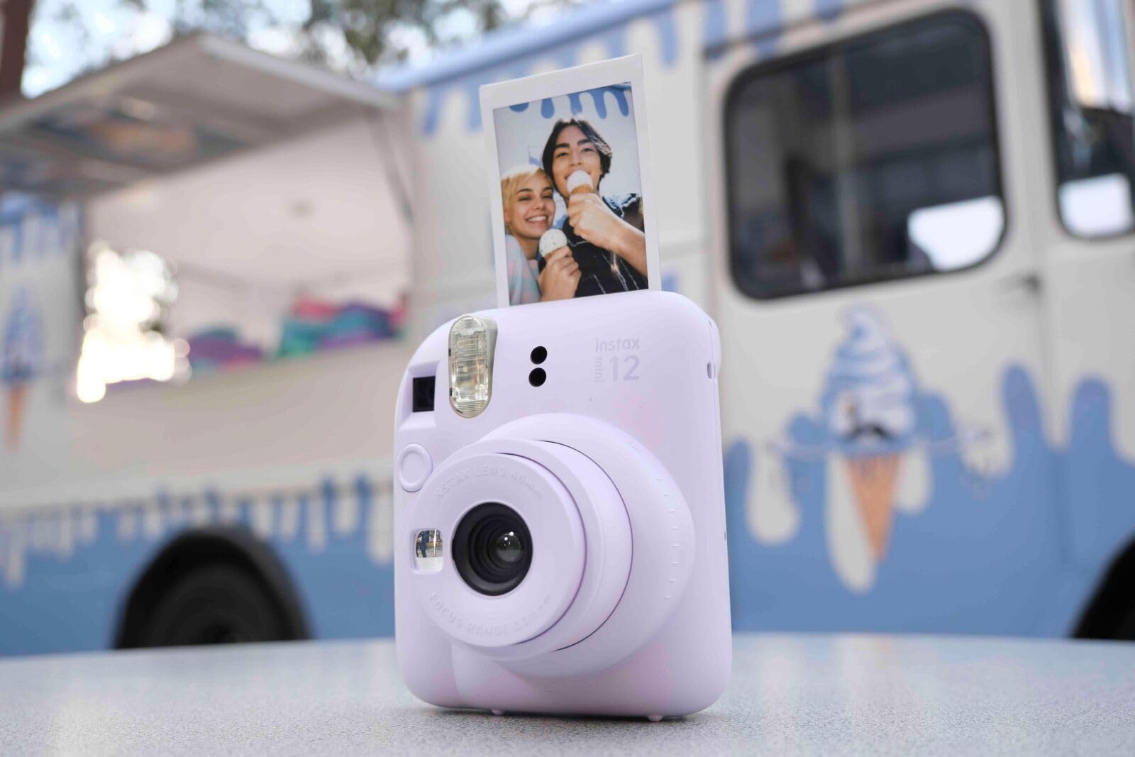 Fujifilm Instax Mini 12 box with strap batteries and manual showing ready-to-use kit