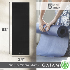 Gaiam mat rolled next to a water bottle showing portability and compactness