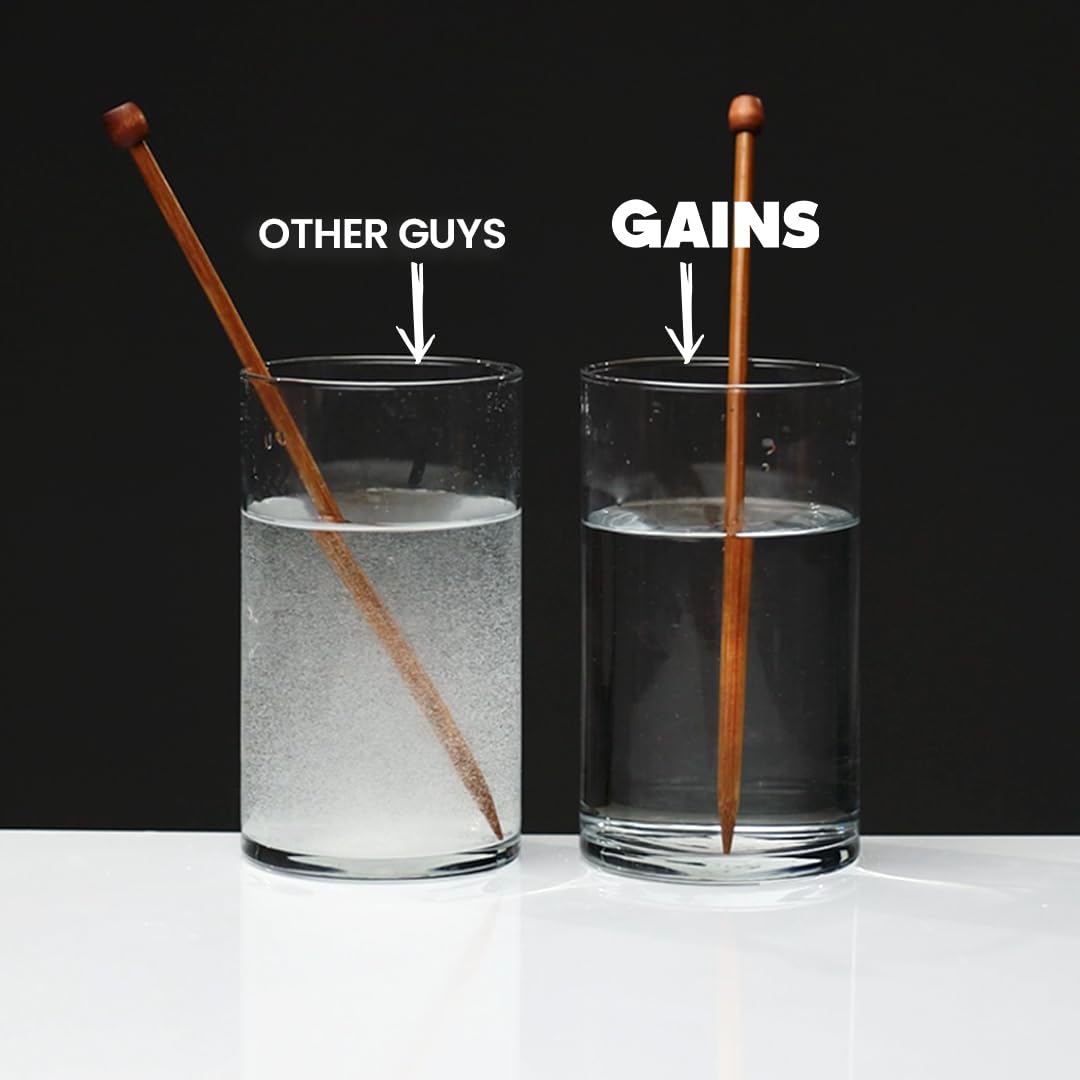 Glass with Gains in Bulk mixed creatine showing clear solution and no sediment for easy digestion
