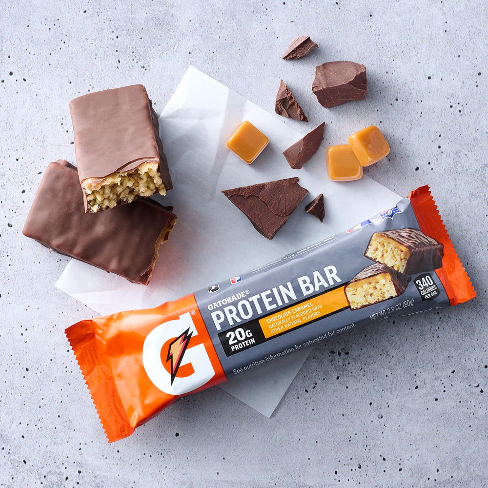 Gatorade Recover bar held at gym bench showing quick post-workout snack