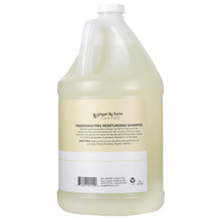 Ginger Lily Farms shampoo pouring into a dispenser, highlighting easy commercial refill
