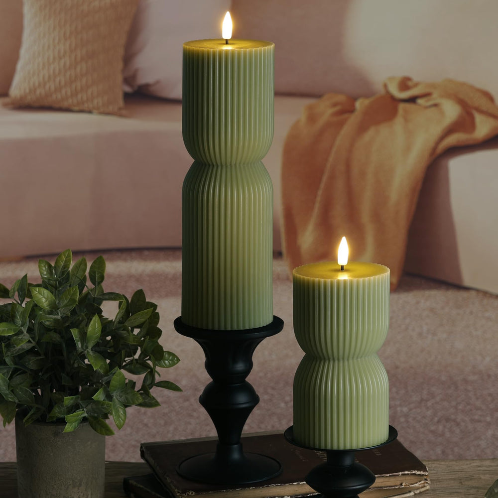 Open battery compartment of Girimax candle showing easy AA battery access and long runtime