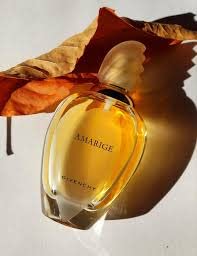Givenchy Amarige sprayed from bottle in hand, demonstrating application benefit
