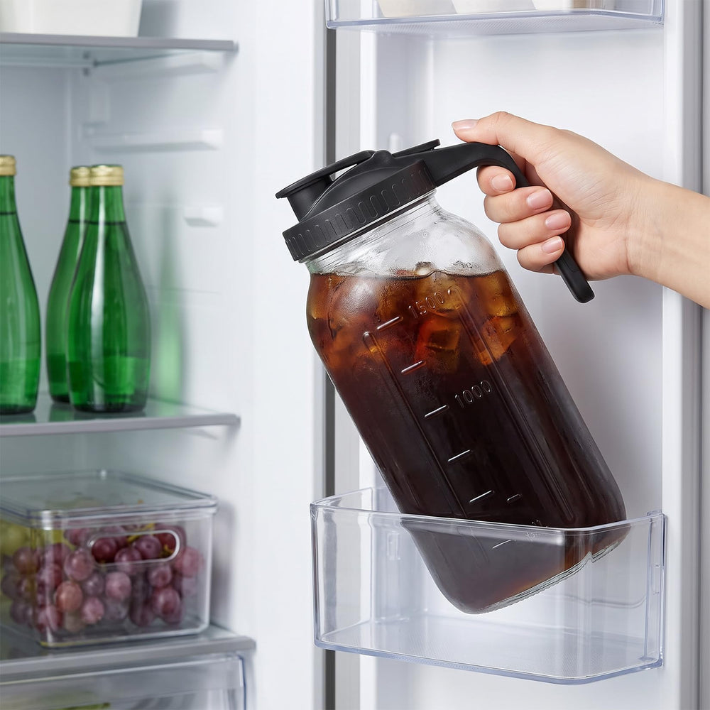 Glabotoil pitcher beside regular drinking glass to show real size scale