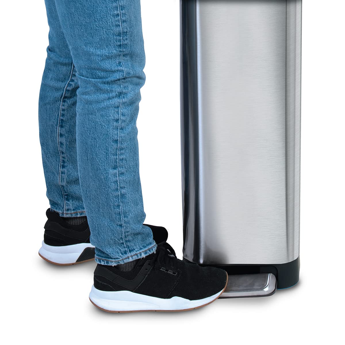 Glad next to chair for size comparison showing 12 gallon capacity and narrow footprint