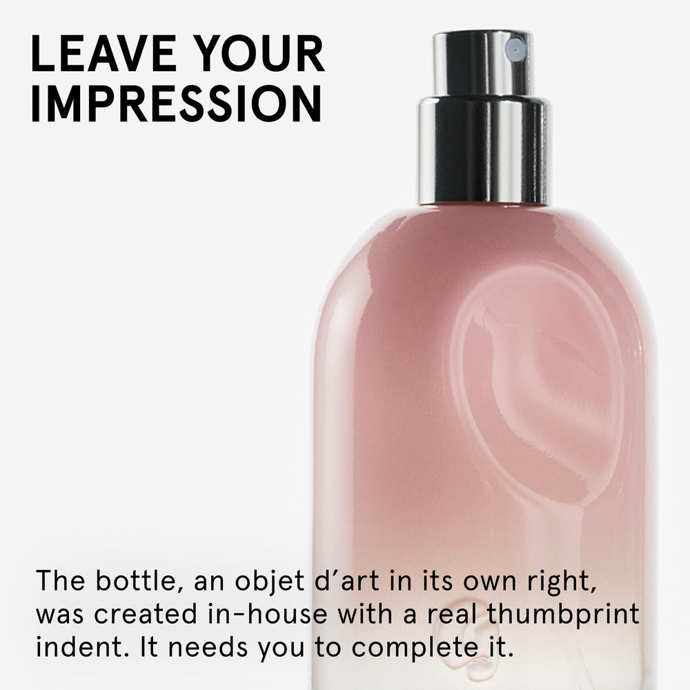 Glossier You travel bottle beside keychain showing portable scale