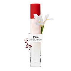Glossier You travel bottle front view showing compact design and brand