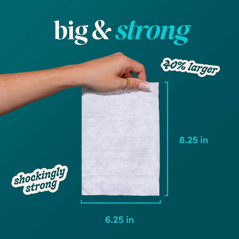 goodwipes folded wipe beside a hand showing extra-large size for improved coverage