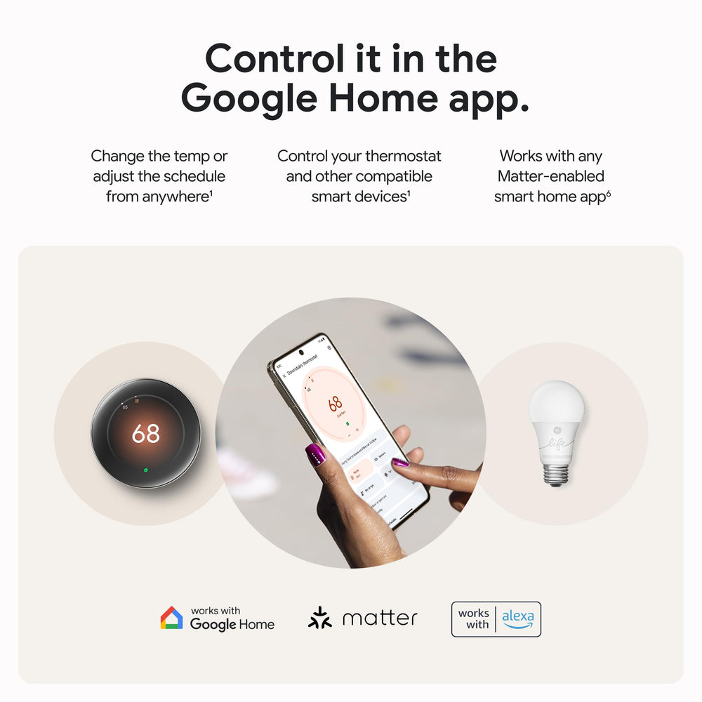 Hand holding Nest thermostat to show actual size for accurate scale comparison