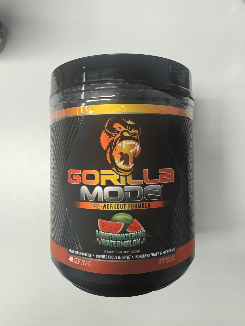 Gorilla Mind tub beside dumbbells conveying strength-focused supplementation for workouts