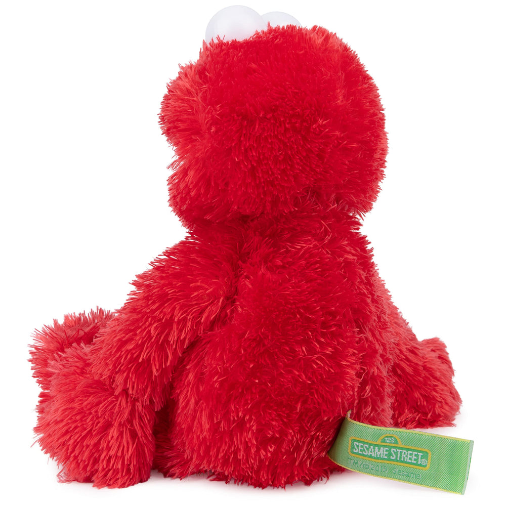 GUND Elmo in child's arms demonstrating comforting cuddle