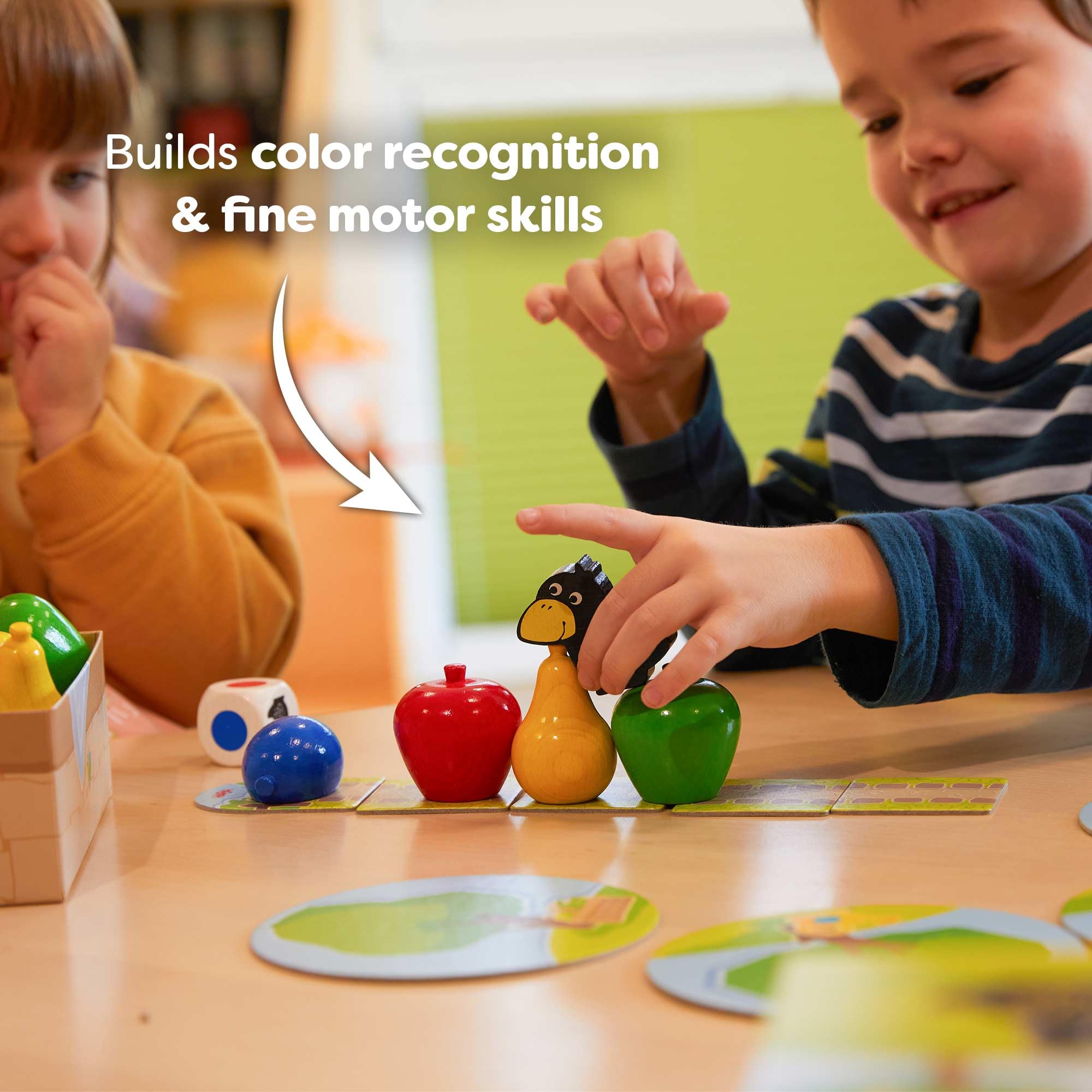 Child playing HABA First Orchard demonstrating fine motor skill practice