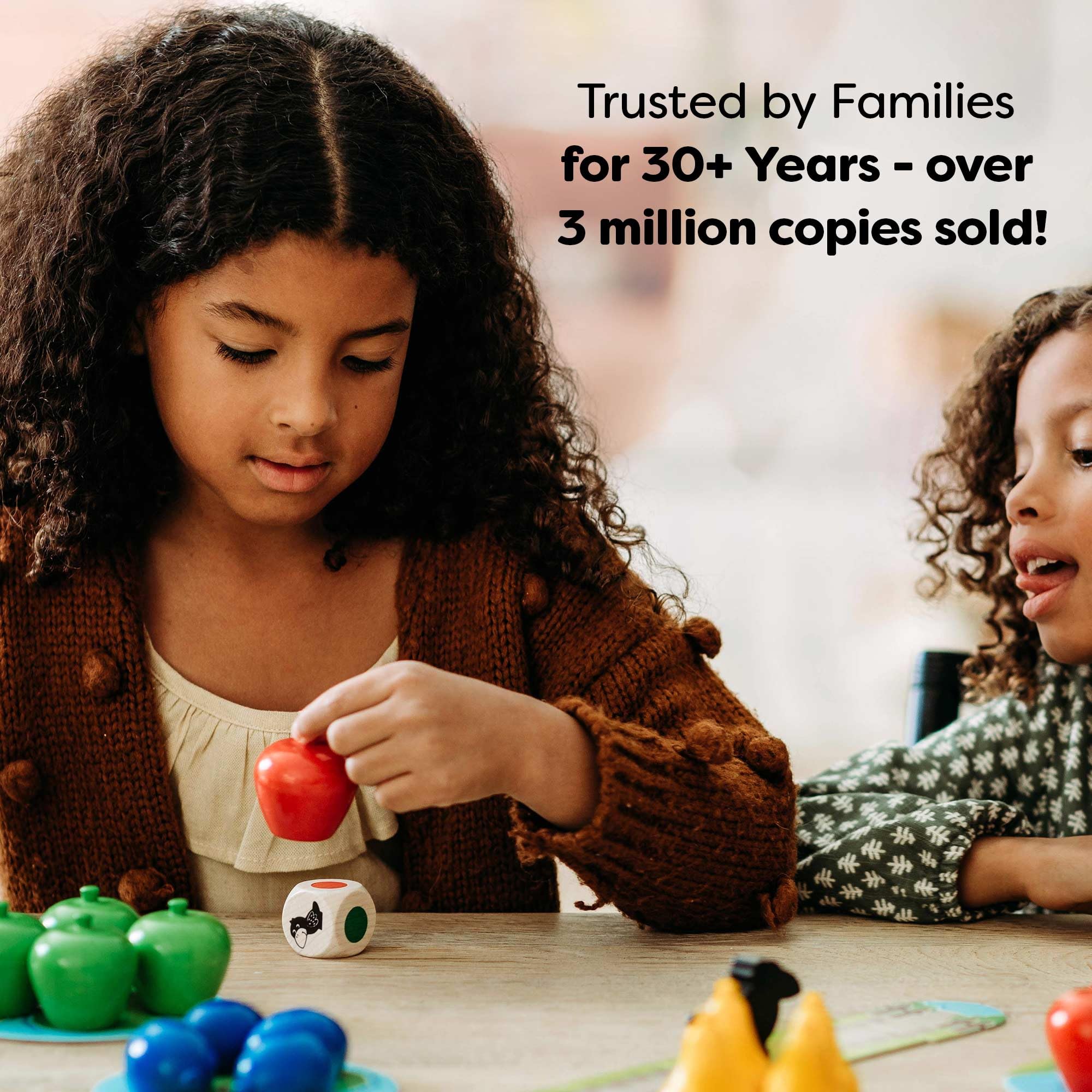 Family playing HABA First Orchard lifestyle shot promoting shared learning time
