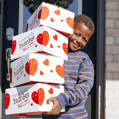 Heavenly Hunks bag beside a hand for serving-size comparison and portion control