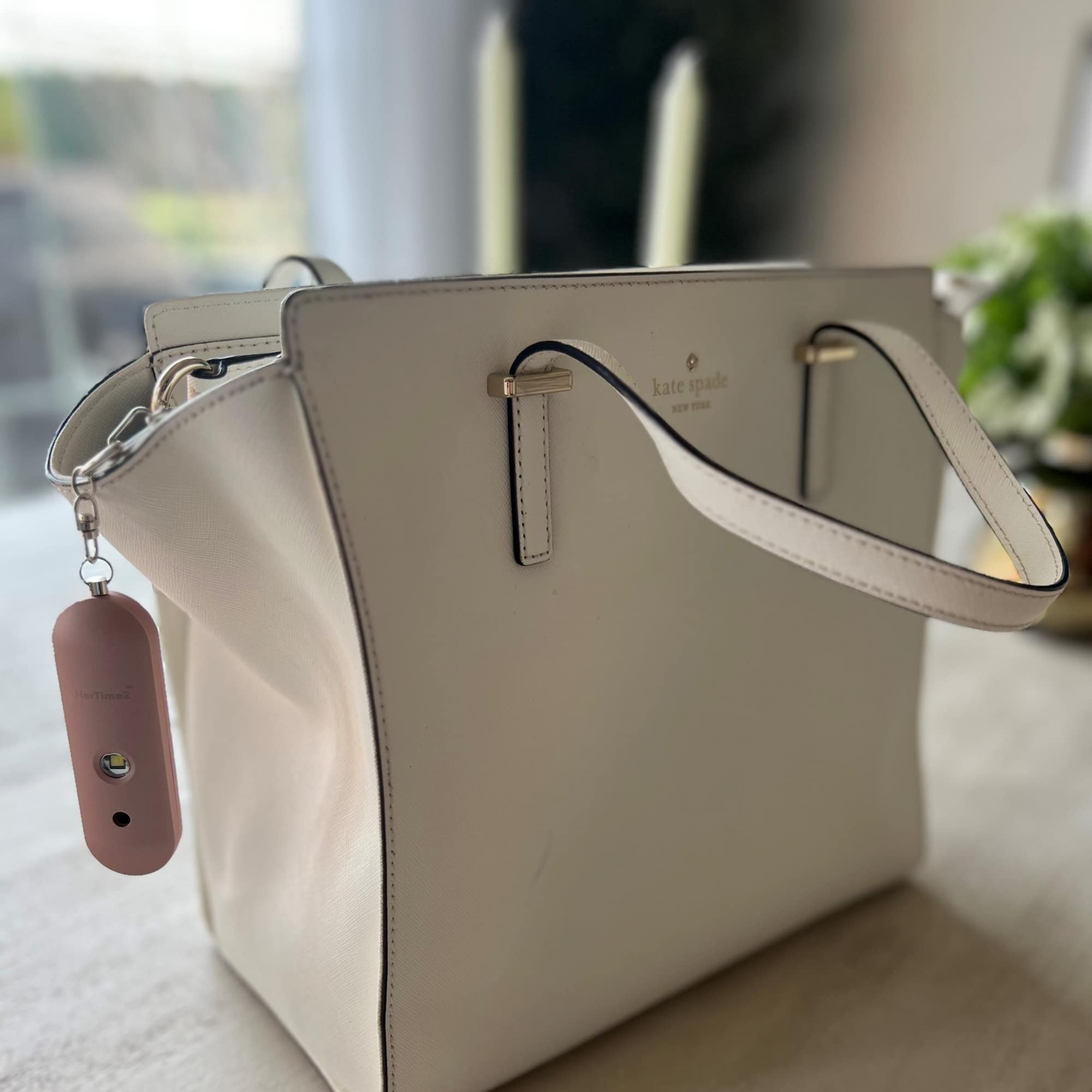 HerTime2 clipped to backpack during evening walk portraying personal safety use