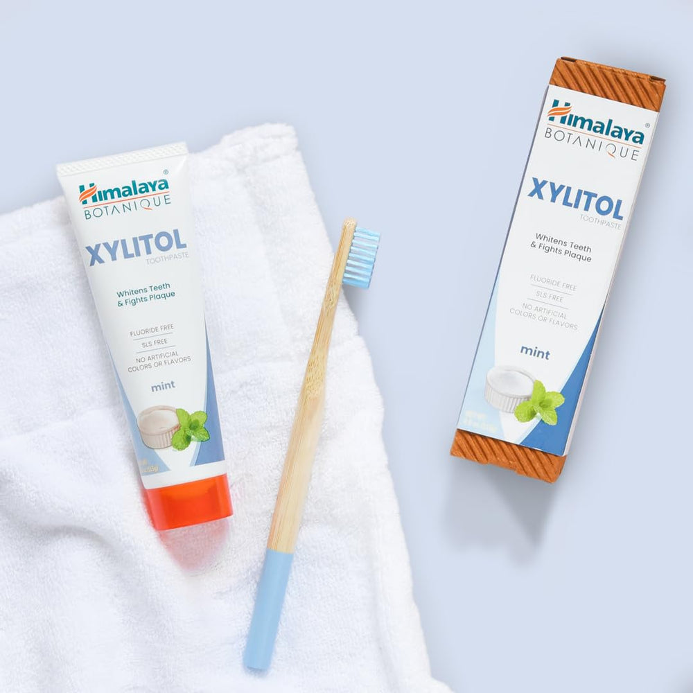 Himalaya toothpaste next to ruler showing 4 oz tube size for accurate scale