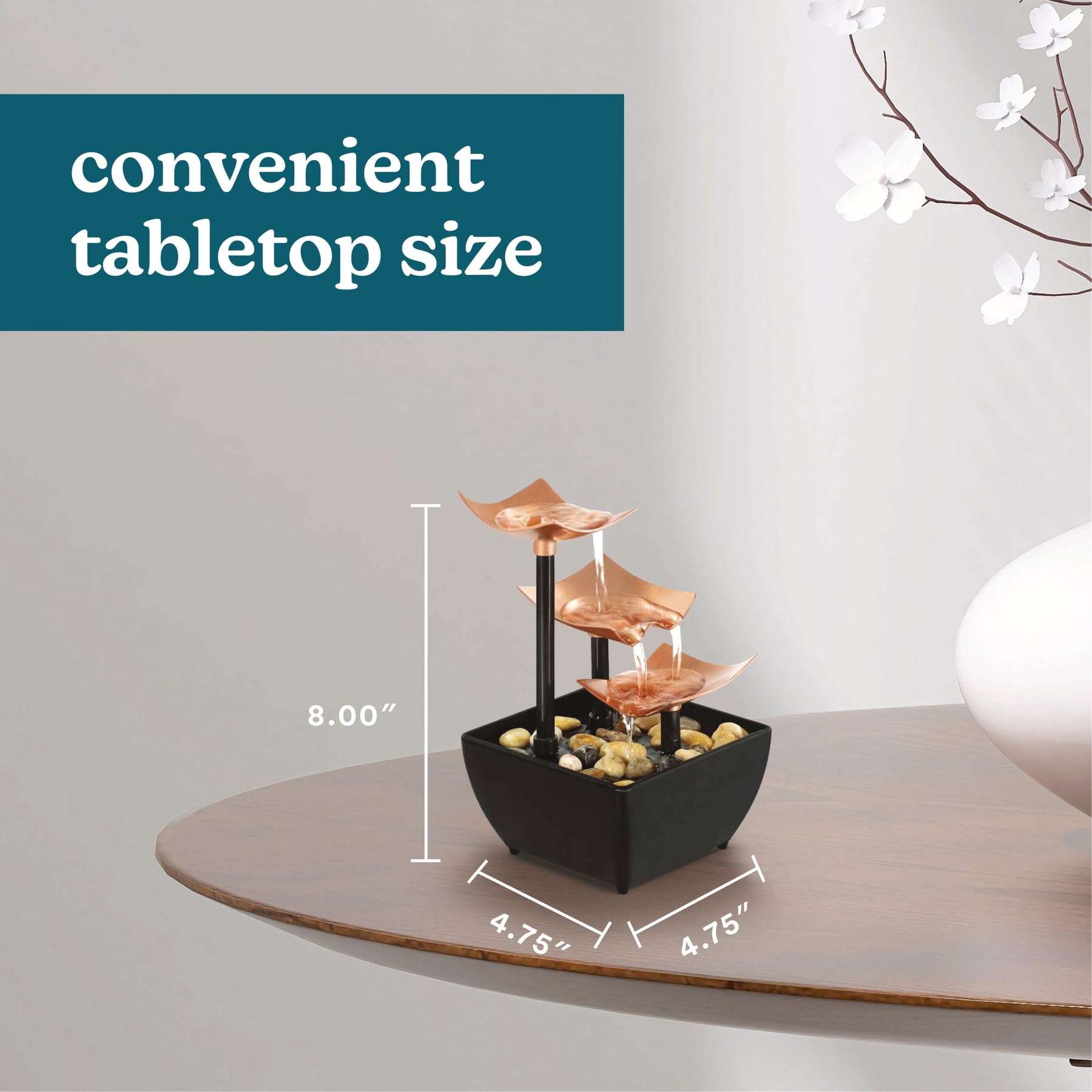 Homedics fountain next to hand for scale illustrating compact, tabletop benefit