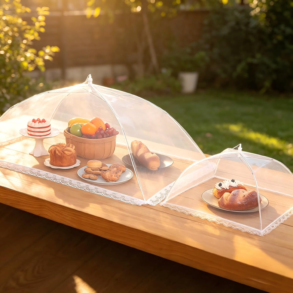 HOMKULA XXL cover open on picnic table shielding tall cake and plates