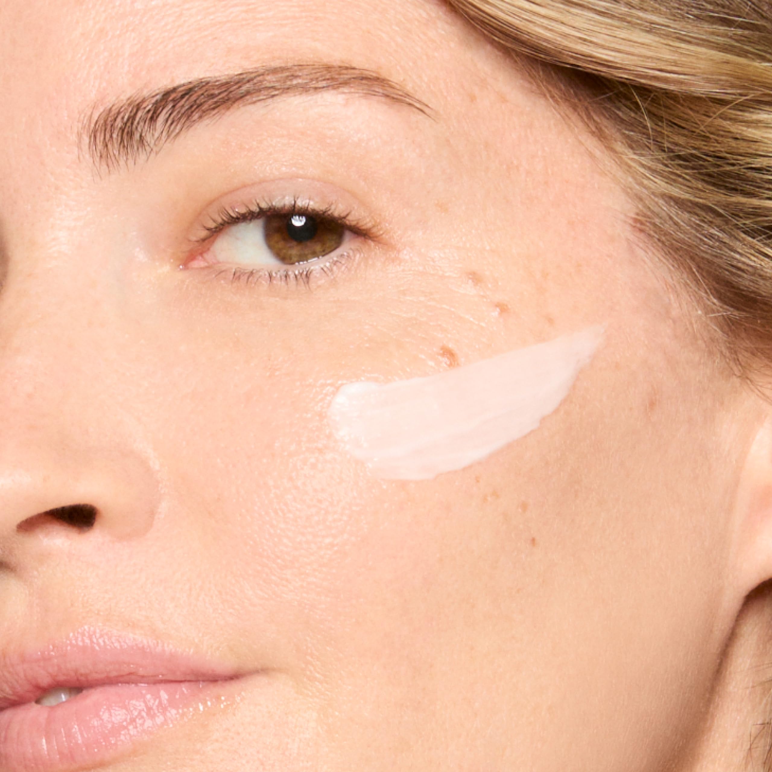 Honest Beauty applying moisturizer to cheek showing calming effect and redness reduction benefit