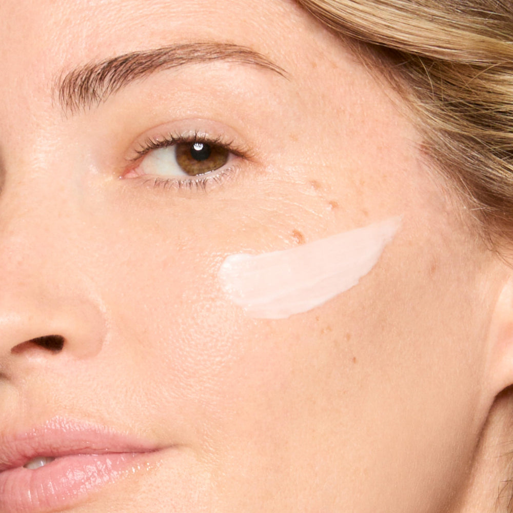 Honest Beauty applying moisturizer to cheek showing calming effect and redness reduction benefit