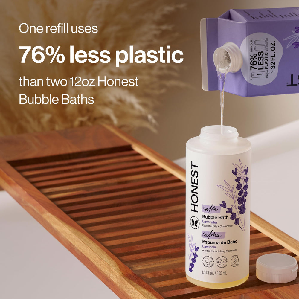 Pouring The Honest Company refill into a bottle for less plastic waste
