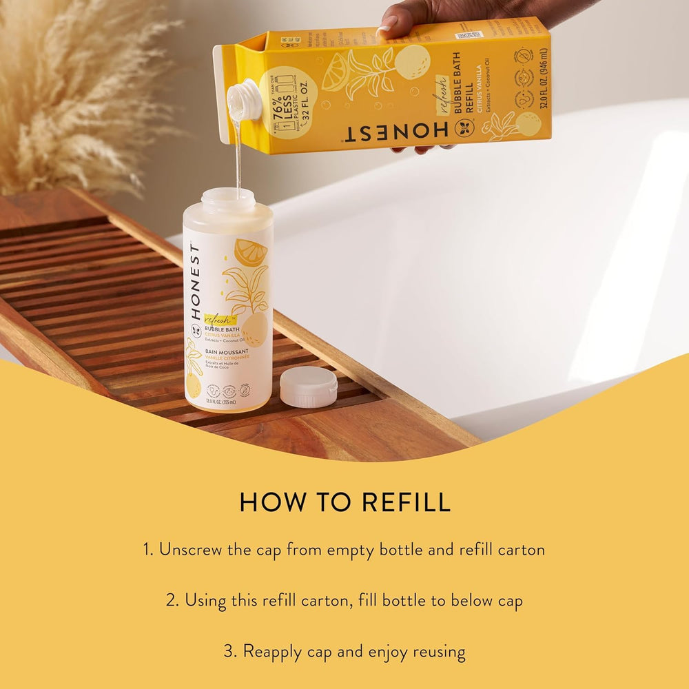 Hand holding The Honest Company 32 fl oz carton to show scale and refill size