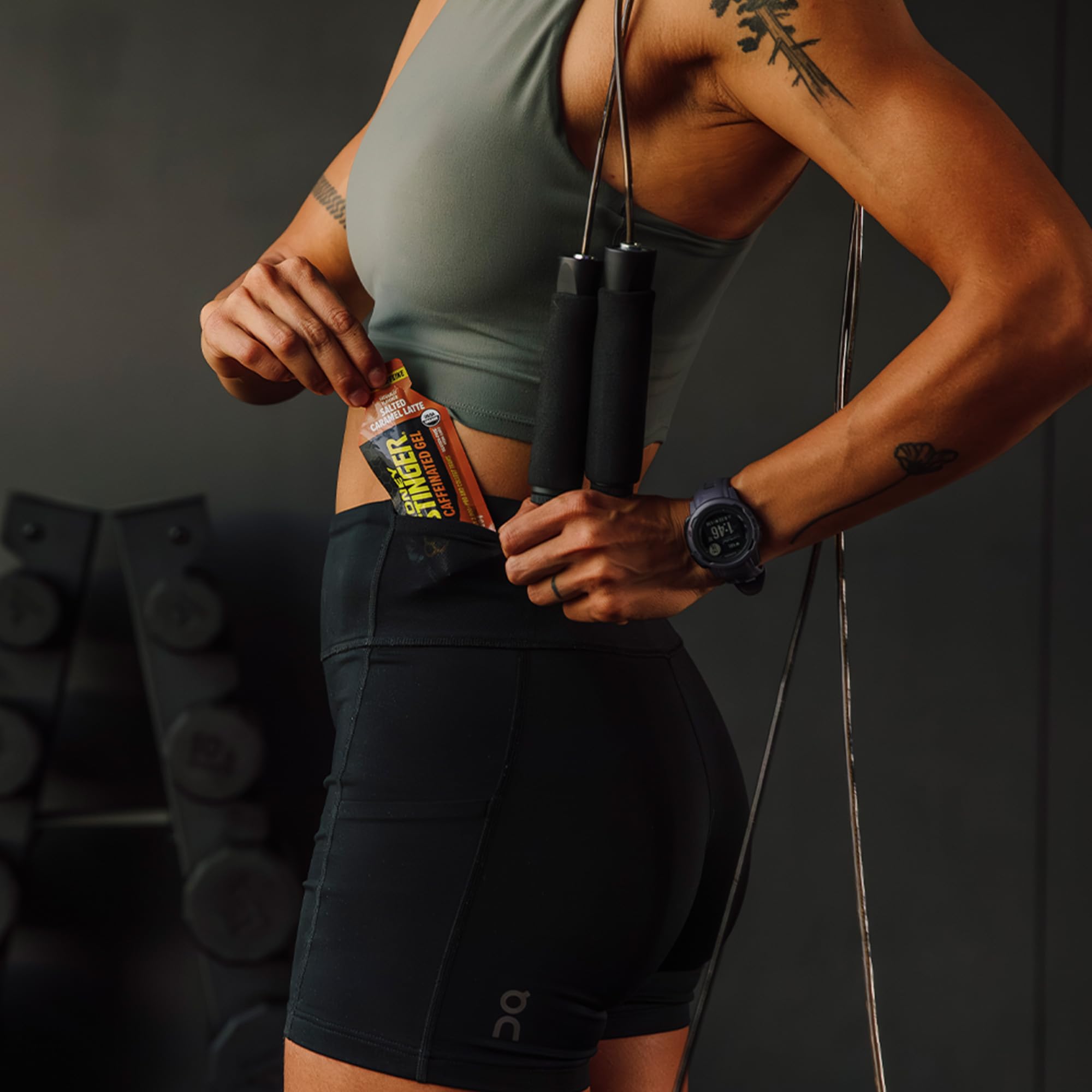 Honey Stinger athlete using gel while running for quick fuel