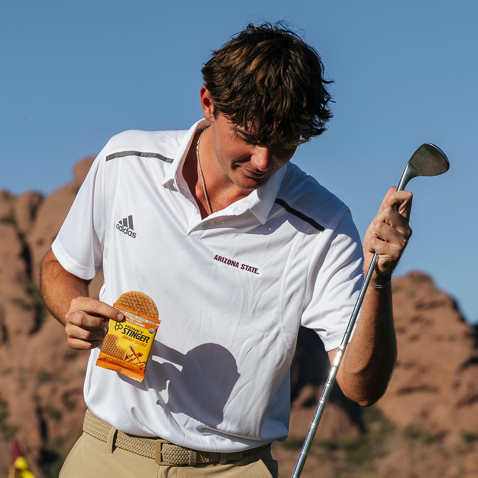 Honey Stinger waffle held in hand showing size and portability for on-the-go fueling