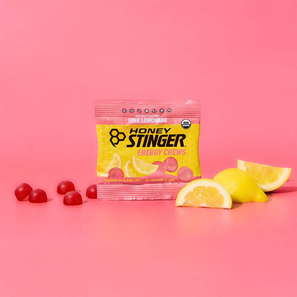 Hand holding several Honey Stinger chews illustrating on-the-go convenience