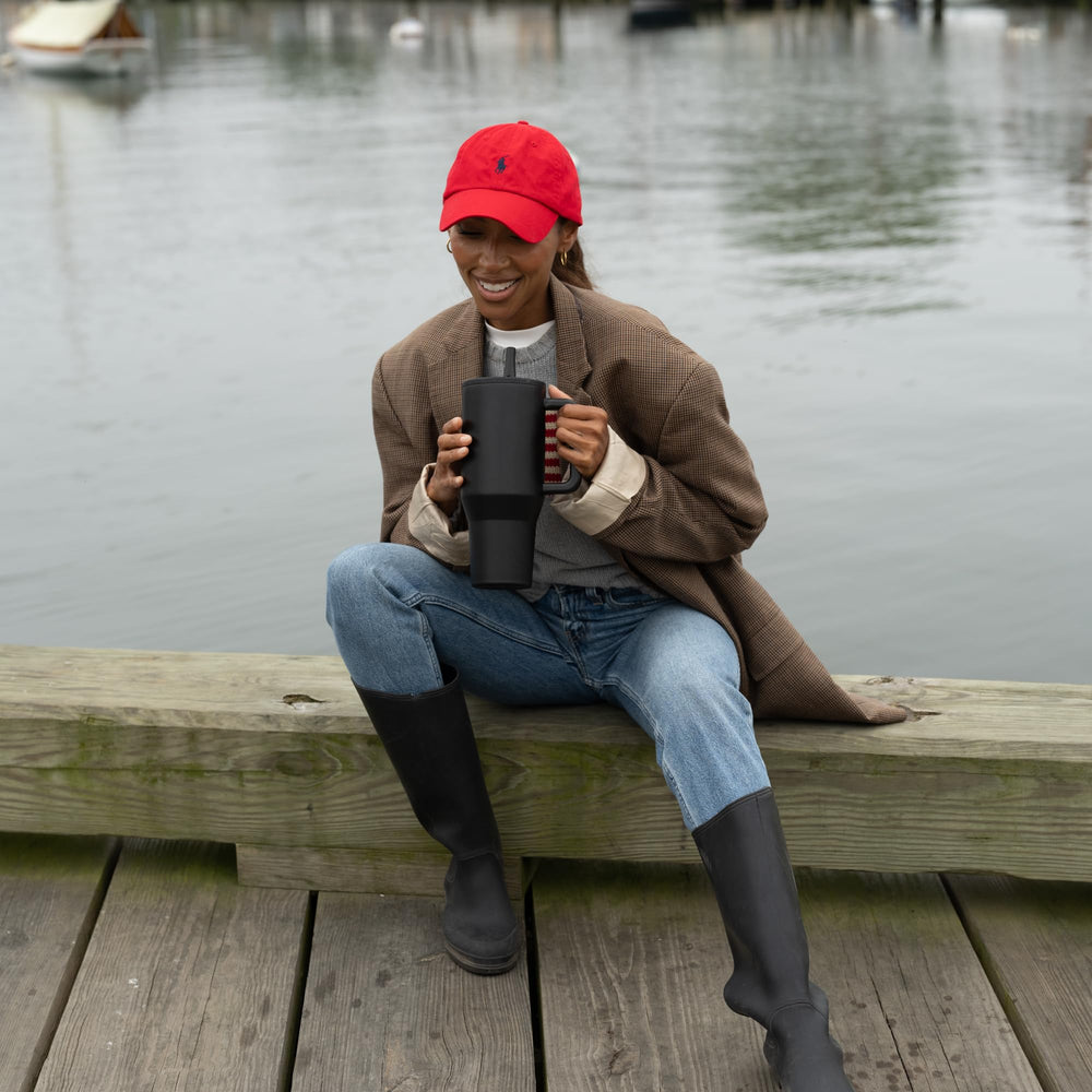 HydroJug Traveler on a commuter seat showing durable travel-ready design and convenience