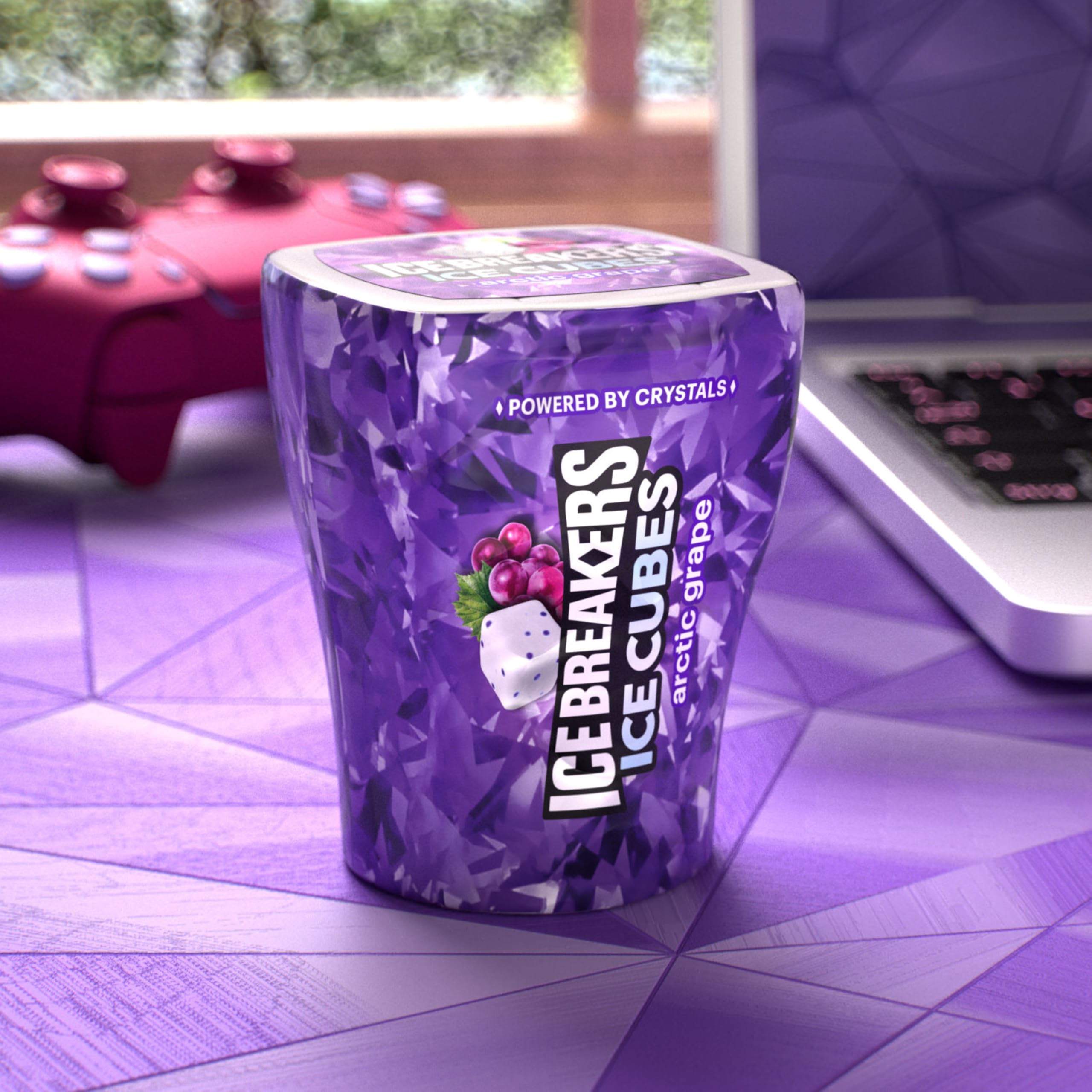 Ice Breakers bottle in hand beside a phone to show compact size benefit