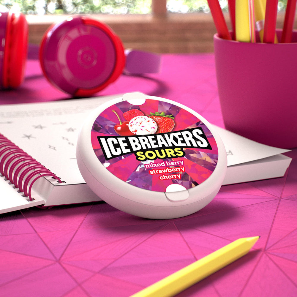 Ice Breakers tin beside a smartphone showing compact 1.5 oz size convenience
