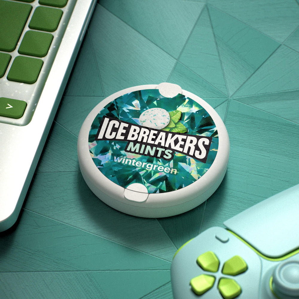 Ice Breakers tin in hand demonstrating pocket-size convenience benefit