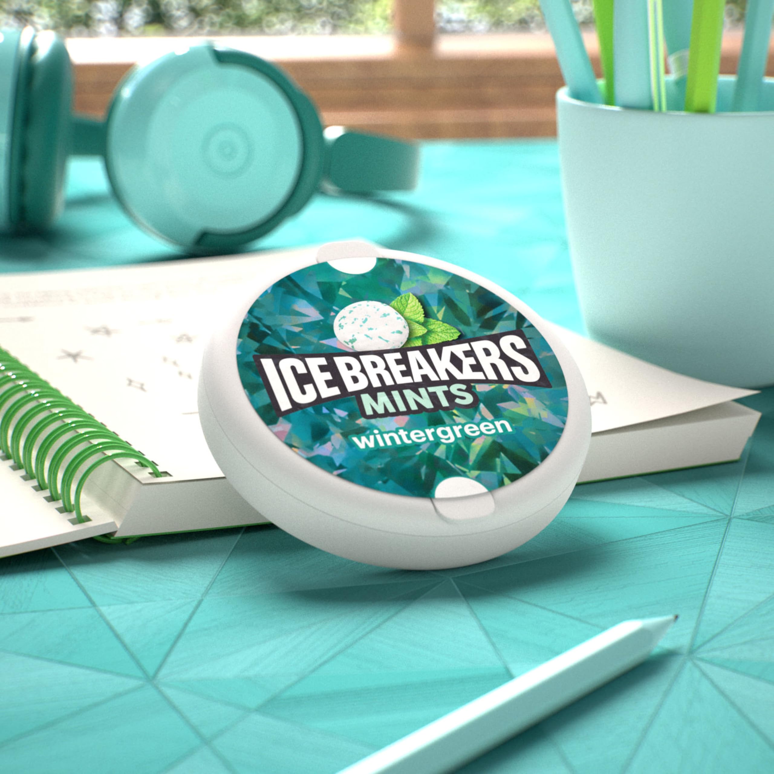 Ice Breakers tins on desk showing workplace freshness and shared supply benefit