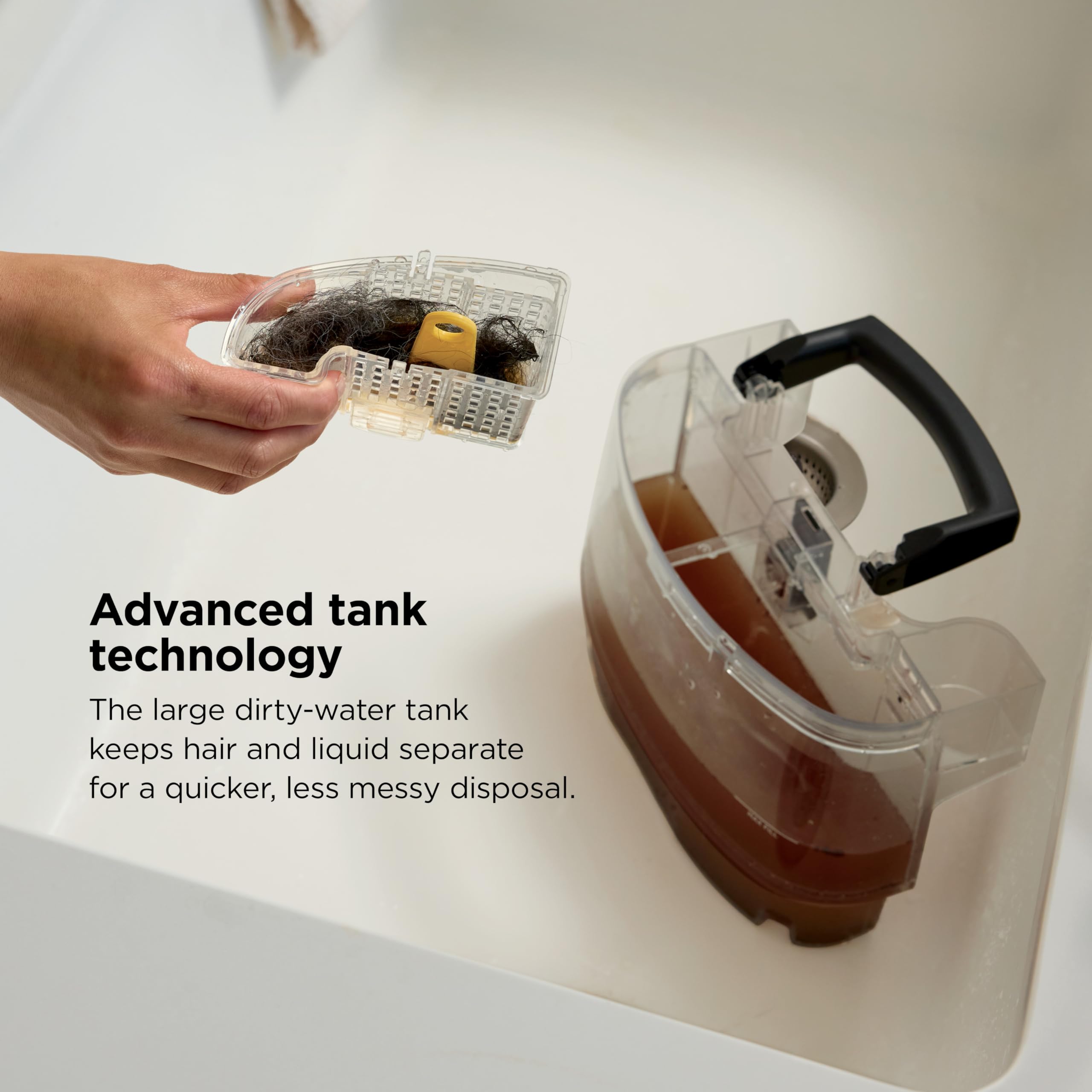 Shark cleaner tank being opened and emptied in a demonstration.