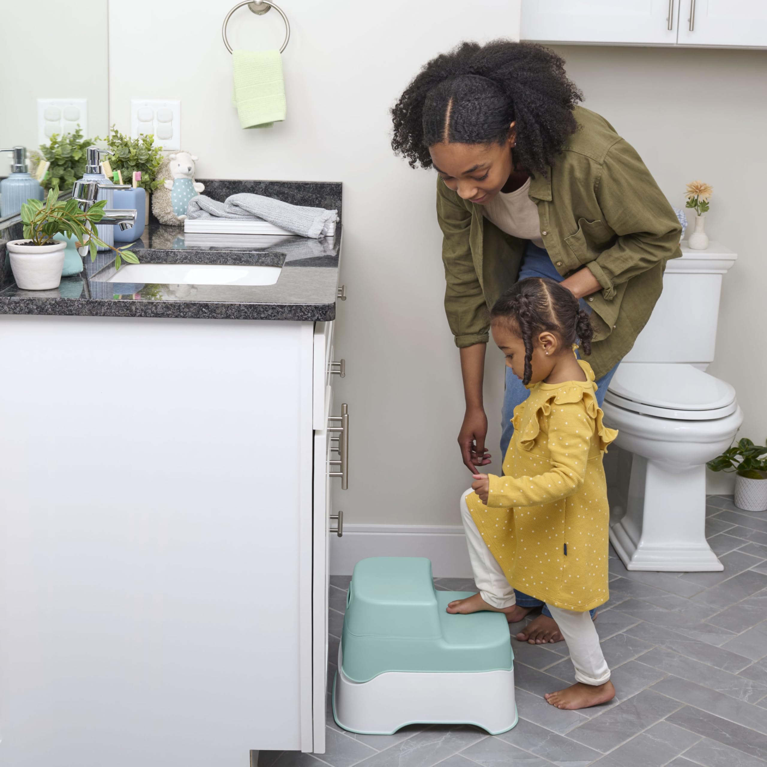 Ingenuity child standing on step stool reaching bathroom sink easily