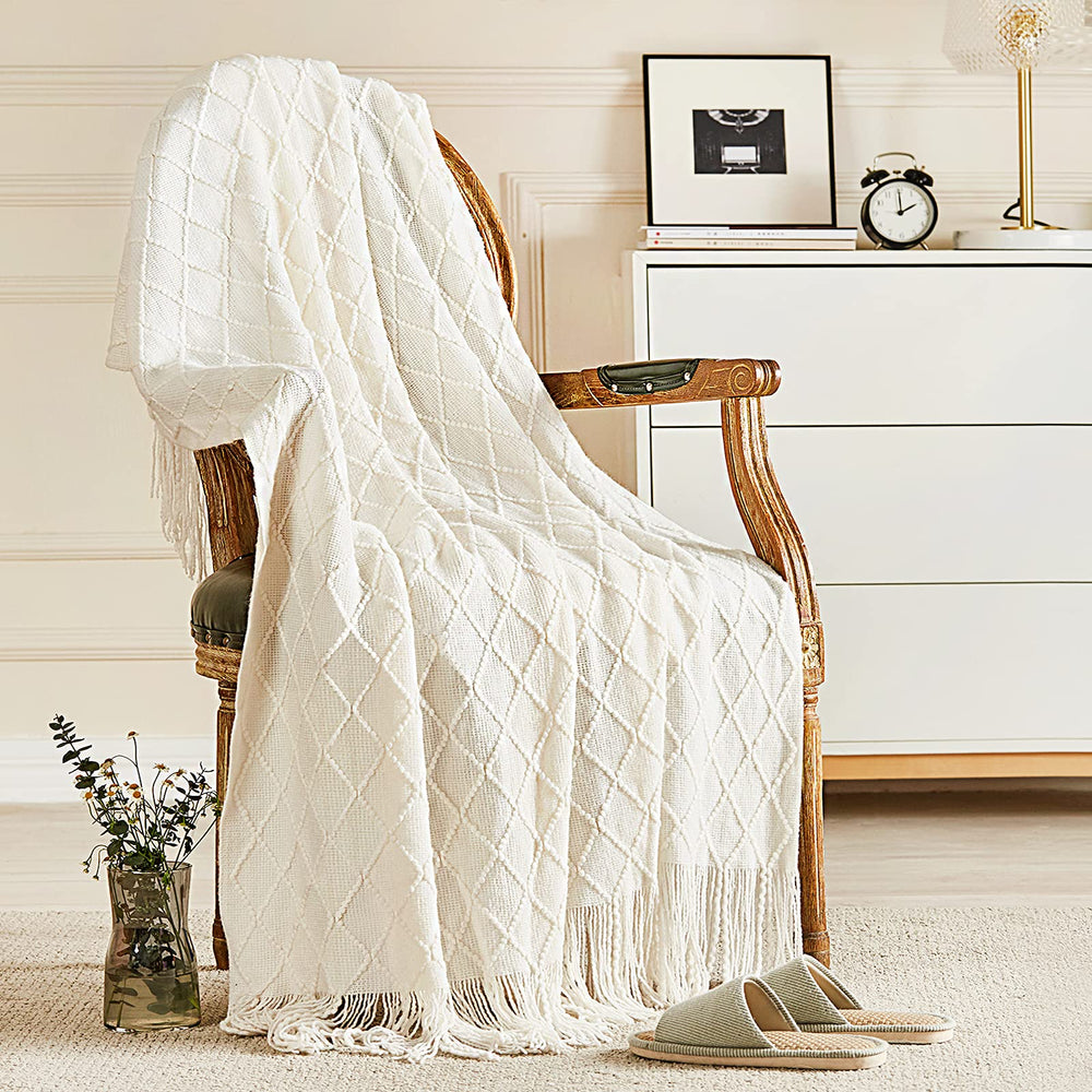 inhand front view of off white knitted throw shows cozy couch styling benefit