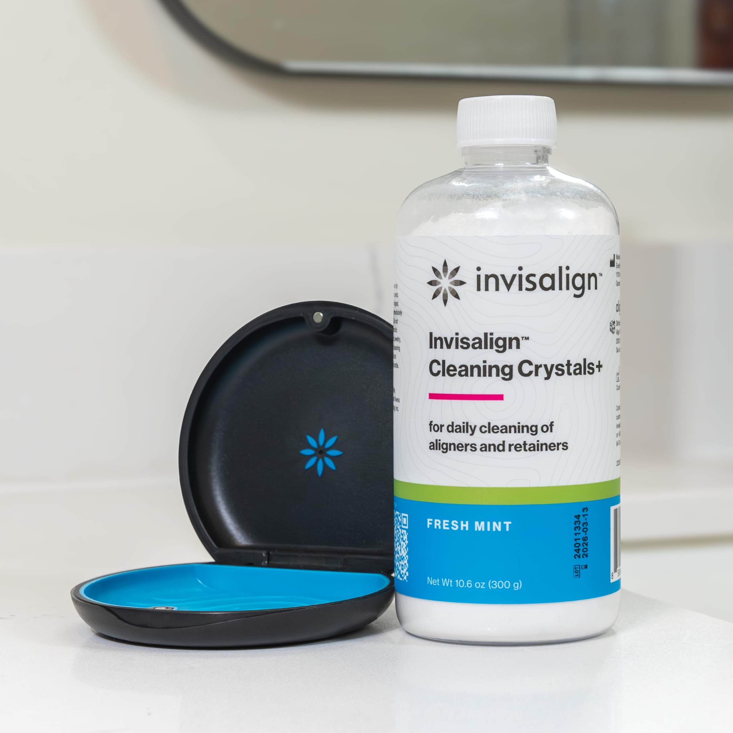 INVISALIGN aligner soaking in container showing stain-removal benefit