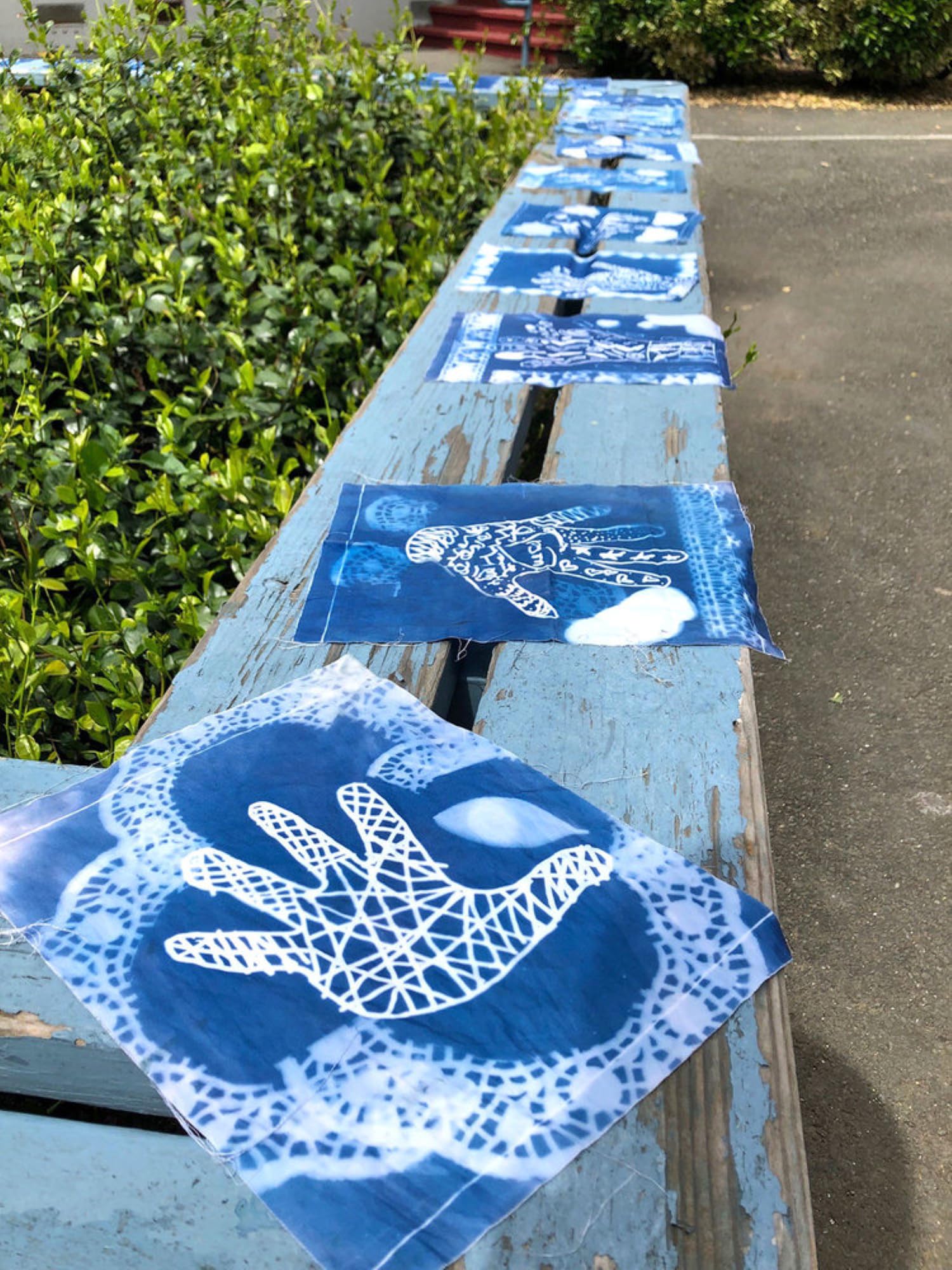 Jacquard workshop scene with participants making cyanotype prints together