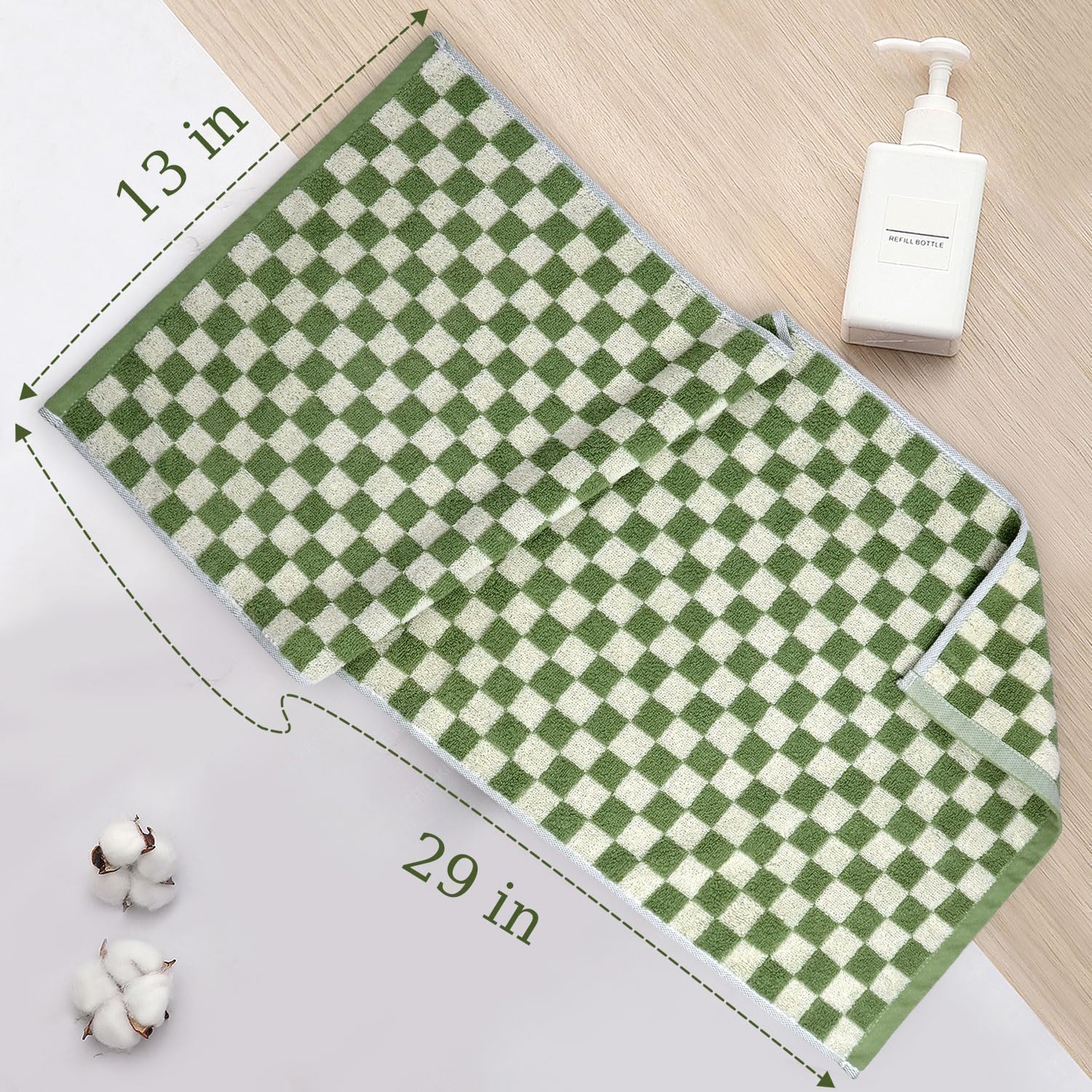 Hand holding Jacquotha towel to show scale and comfortable thickness