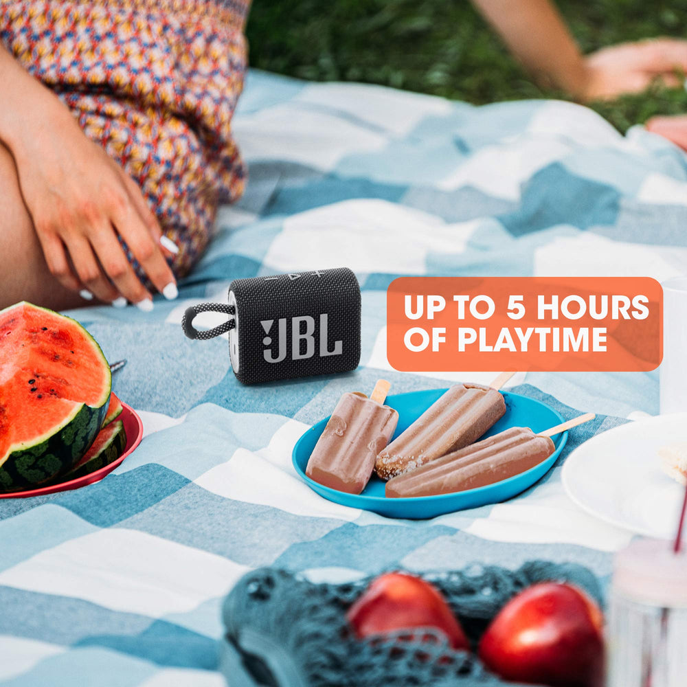 JBL Go 3 next to smartphone for scale, small size convenience