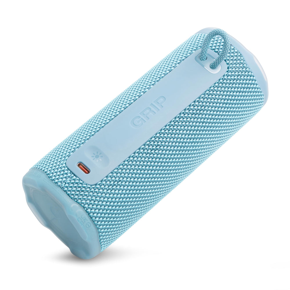 JBL Grip on picnic blanket in teal showing outdoor lifestyle versatility