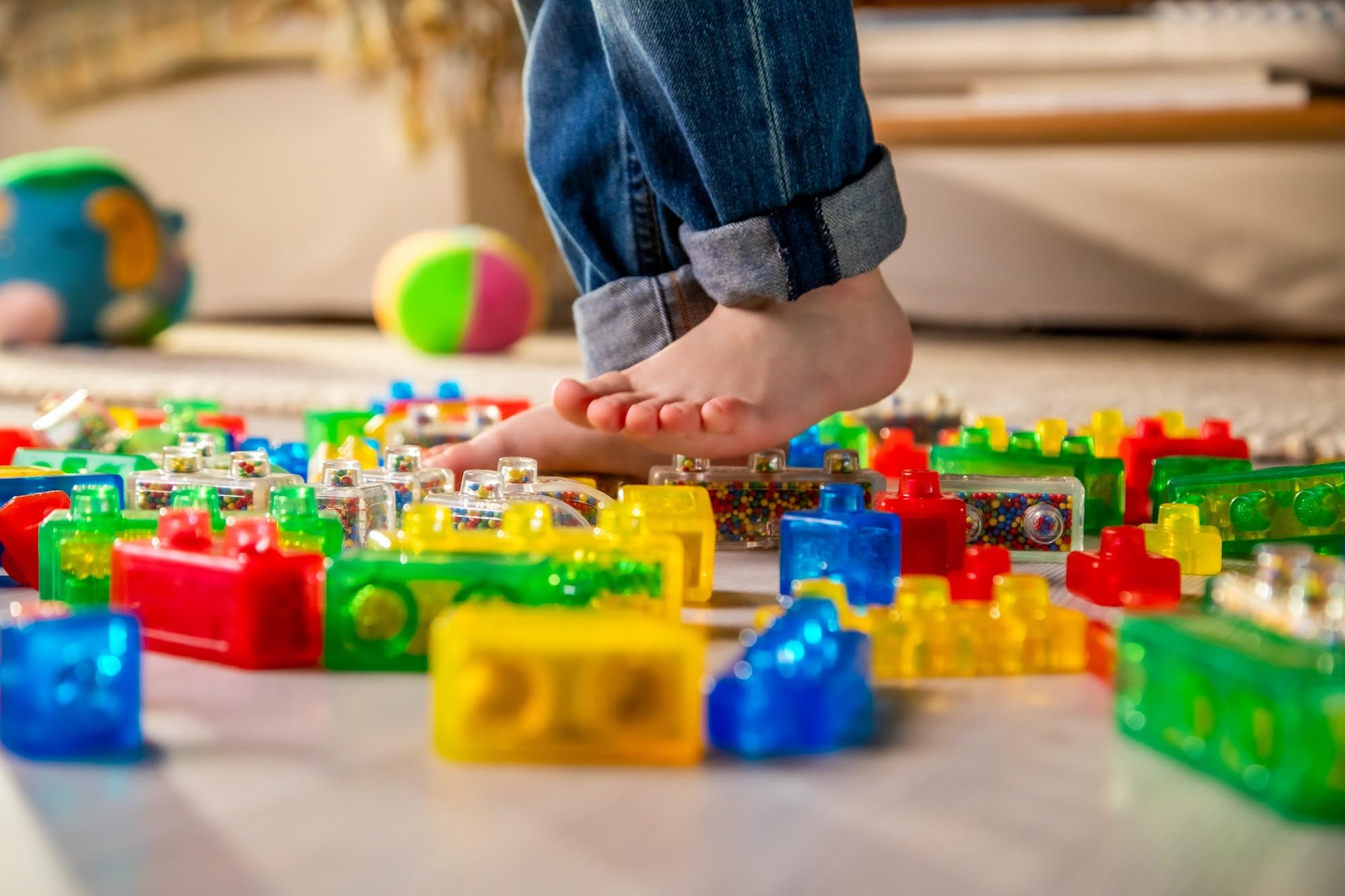Jelly Blox next to adult hand for scale, shows child‑friendly block size benefit