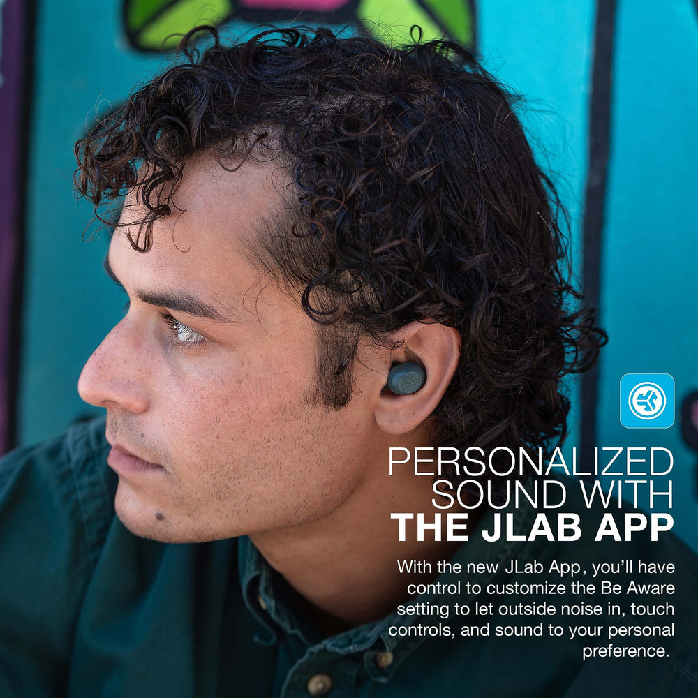 JLab JBuds Mini size comparison beside a coin demonstrating pocket-friendly scale