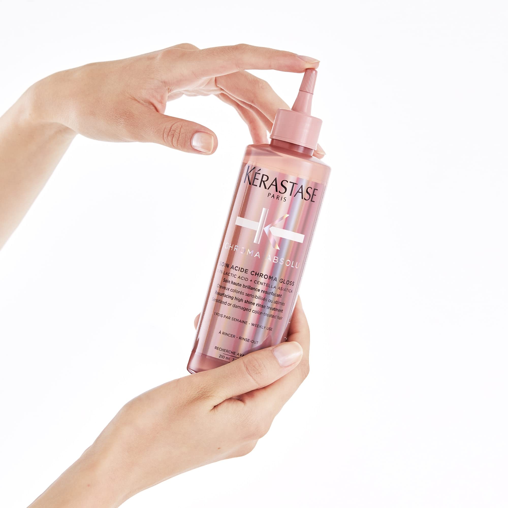 KÉRASTASE bottle next to hand shows true size and portion guidance