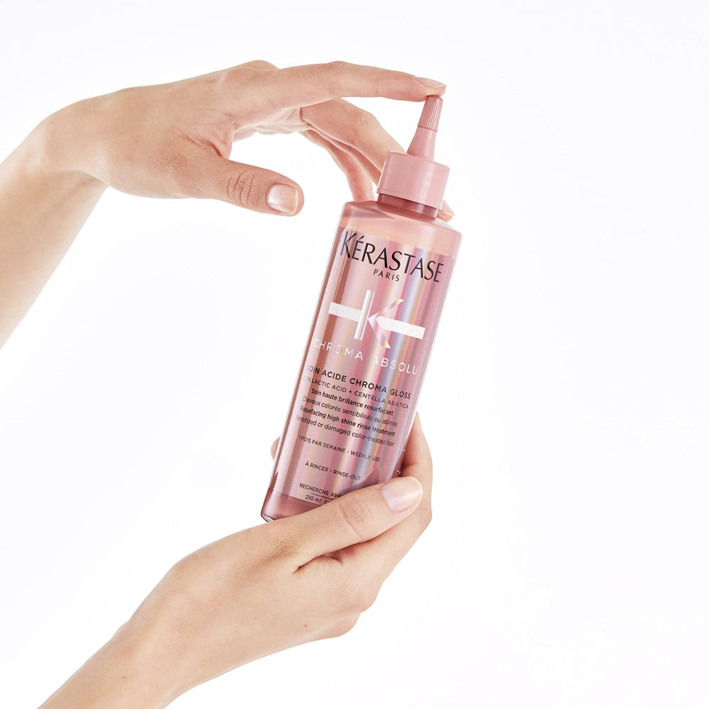 KÉRASTASE bottle next to hand shows true size and portion guidance