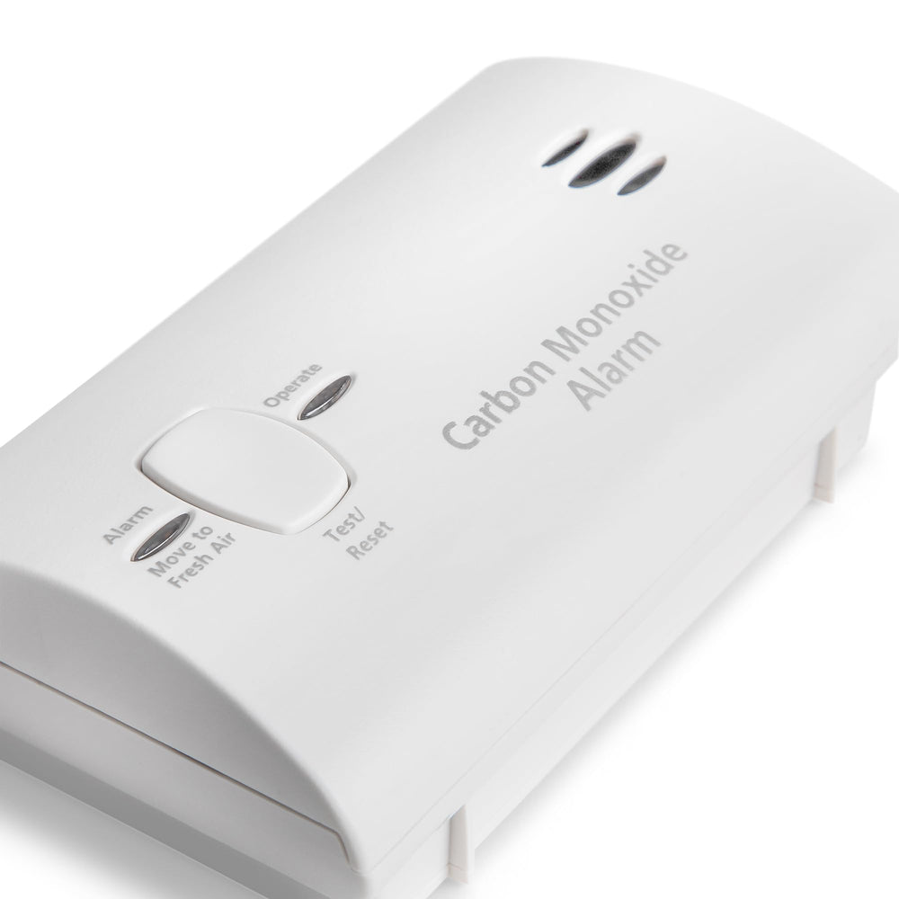 Kidde CO detector on tabletop packed for travel showing portable protection benefit