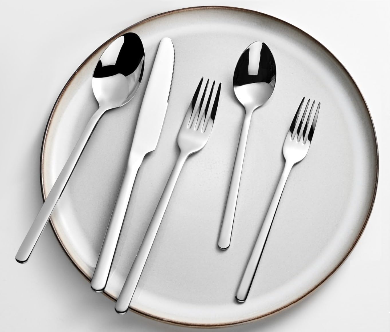 KINGSTONE utensils next to hand showing scale and sturdy weight for confident grip