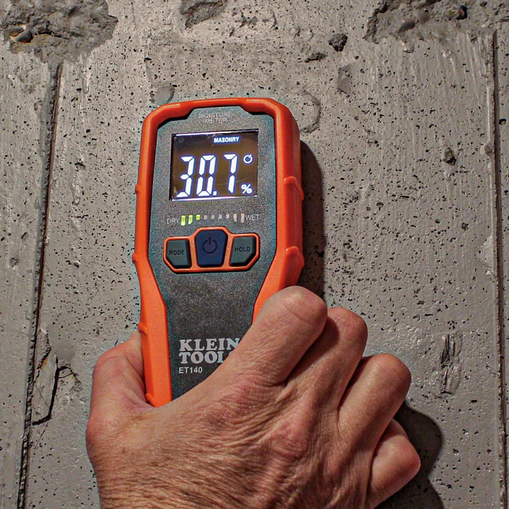 KLEIN TOOLS ET140 positioned against masonry wall to check for hidden damp spots