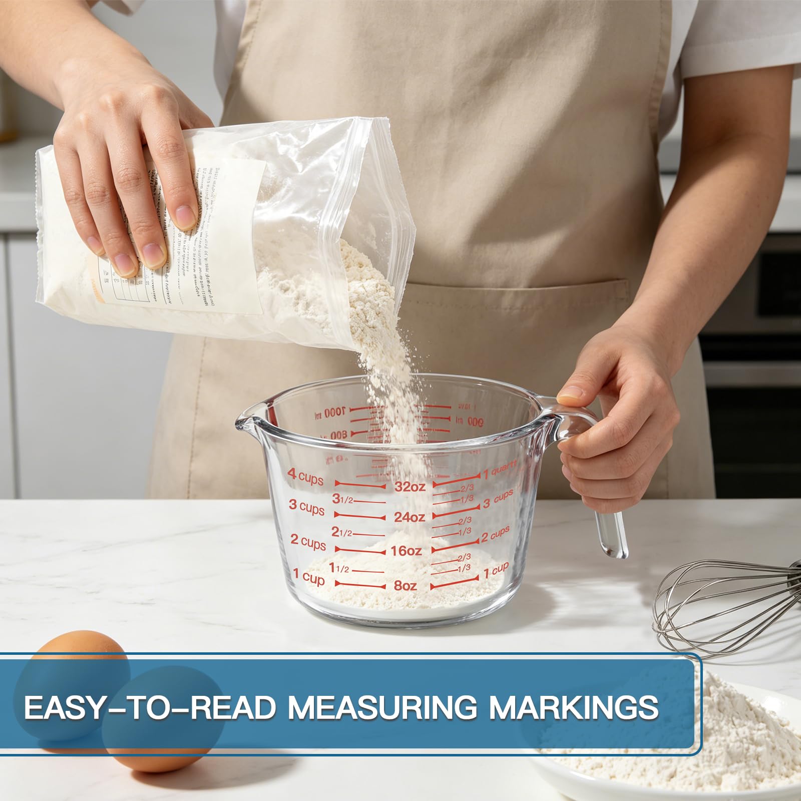 KOMUEE 4-cup glass measuring cup next to a hand for scale and capacity clarity